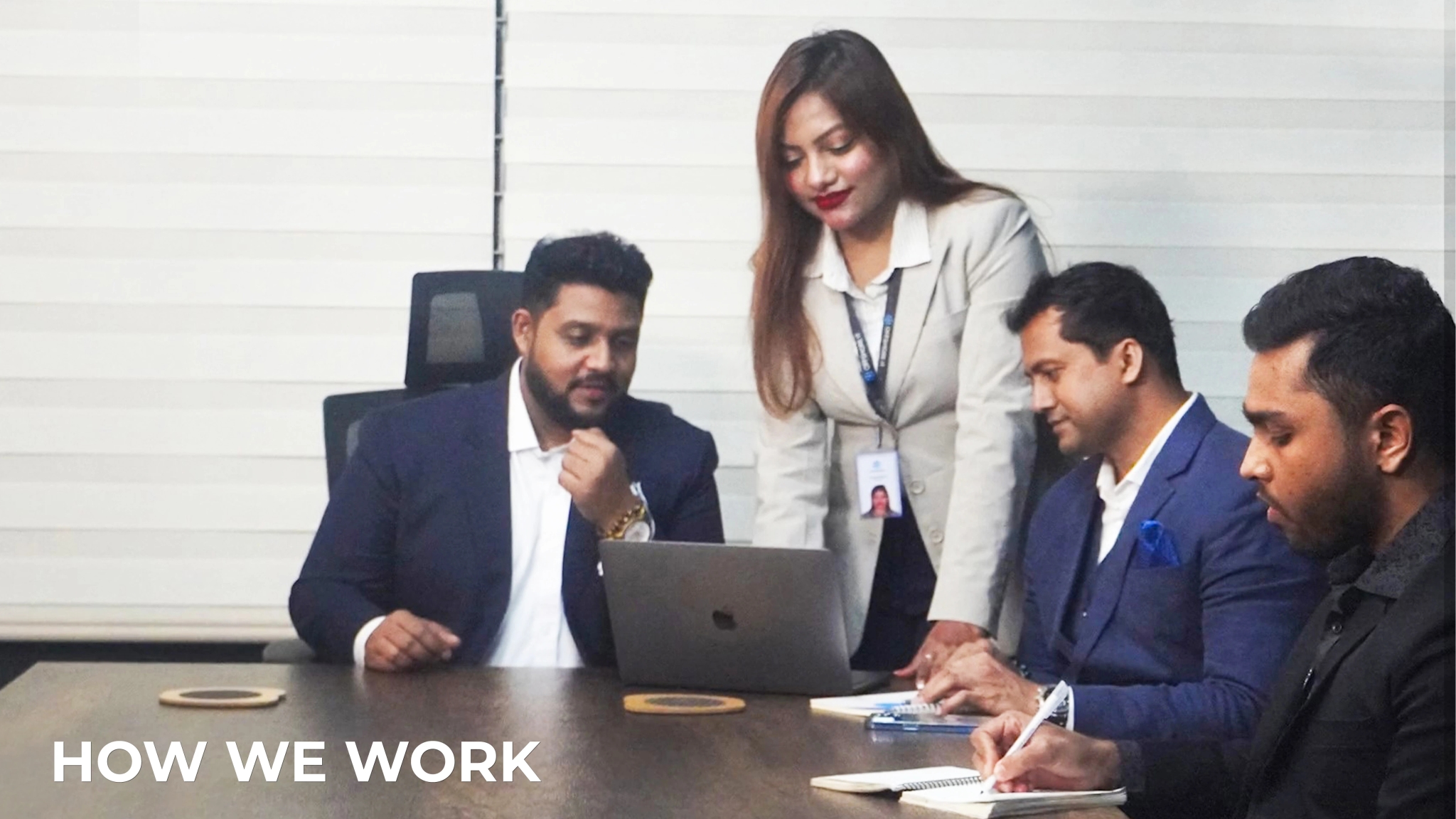 A man and woman stand together in front of a computer, engaged in a work process on the Rankupper.