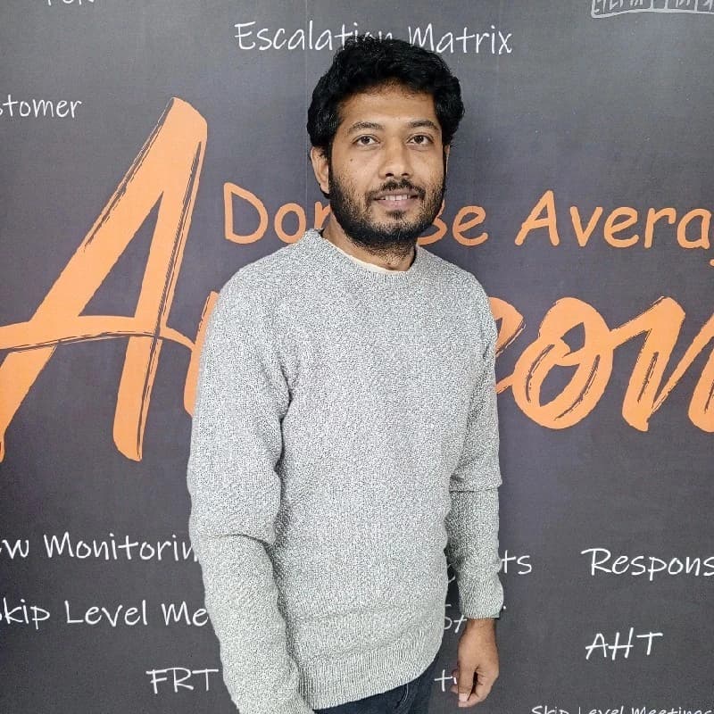 A man in a blue shirt stands with arms crossed, representing Md Mahabur Alam, Senior Software developer at Rankupper.