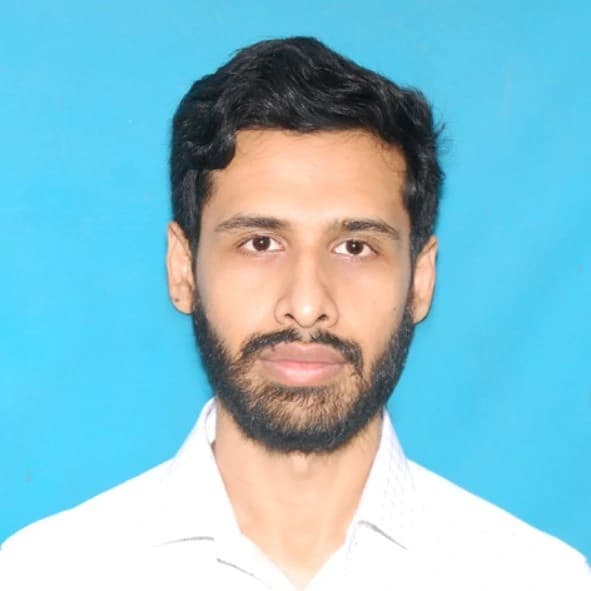 A man in a blue shirt stands with arms crossed, representing Md Mustakim, Senior Software developer at Rankupper.