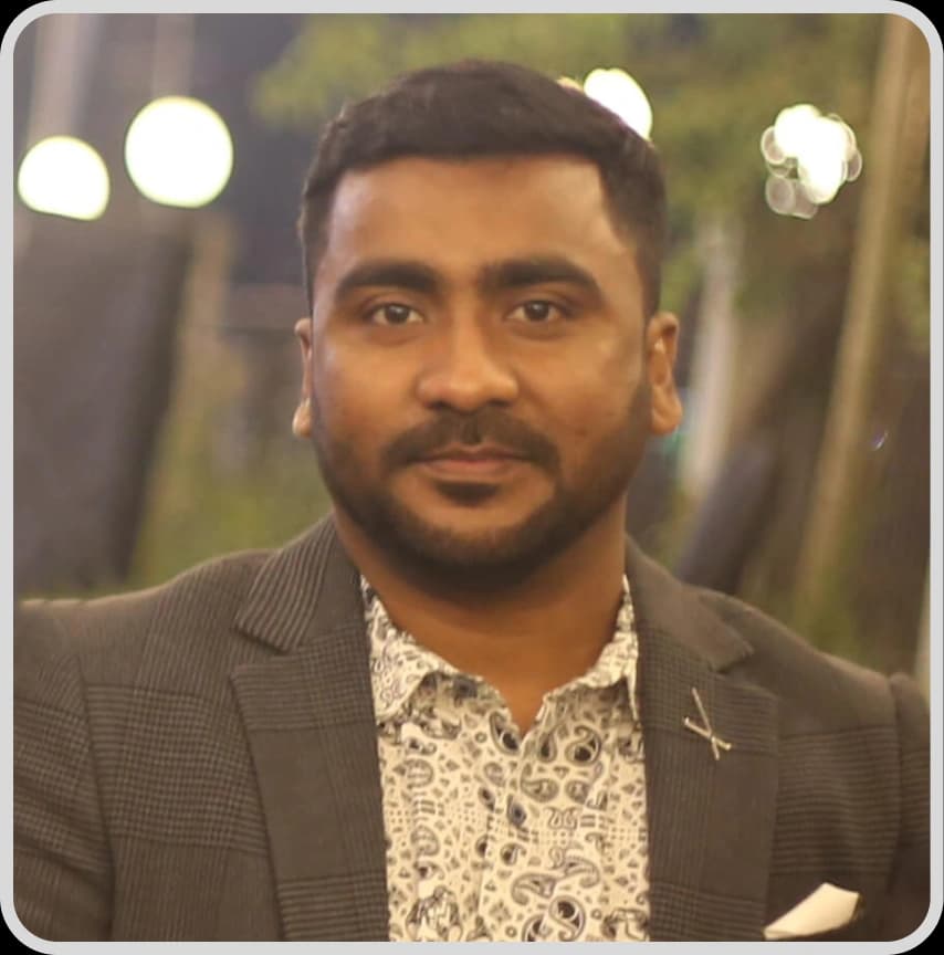 CEO Nayan Chowdhury Rankupper, dressed in a blue suit and white shirt, poses for the camera with a professional demeanor.