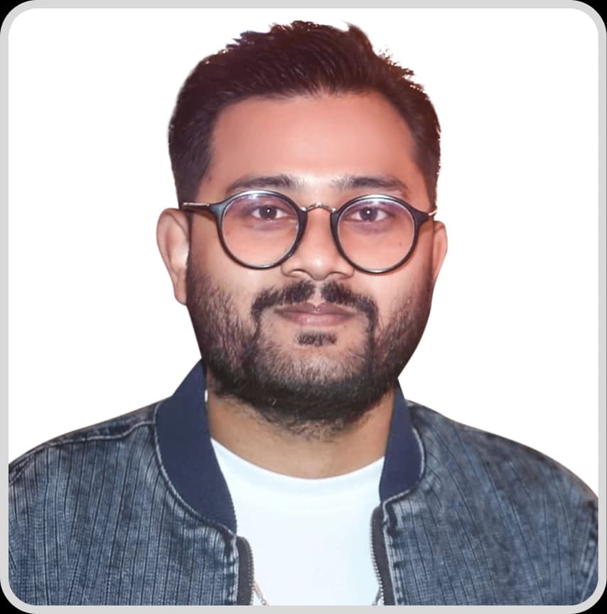 A man in a blue shirt stands with arms crossed, representing Samir Debnath, Senior Admin & HR Executive at Rankupper.