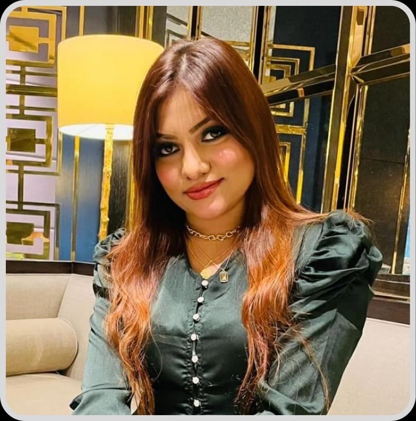 A woman in a blue shirt stands with arms crossed, representing Sonali Sultana, TL (Marketing & CS) at Rankupper.