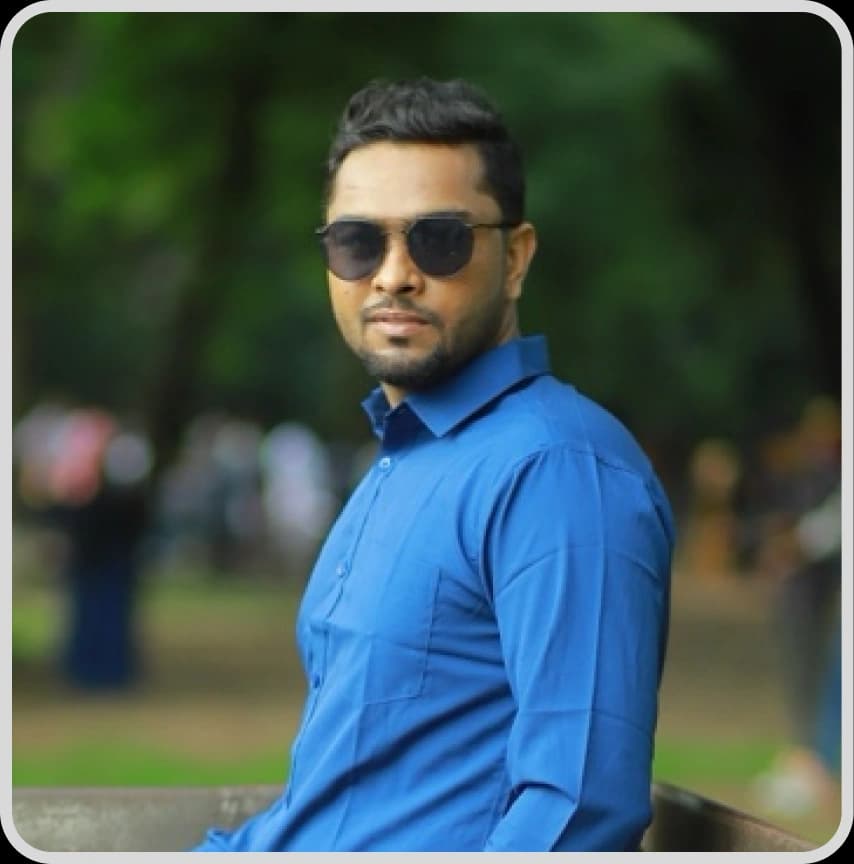 A man in a blue shirt stands with arms crossed, representing Tahsin Ahmed, Sr. Executive, Sales and Marketing at Rankupper.